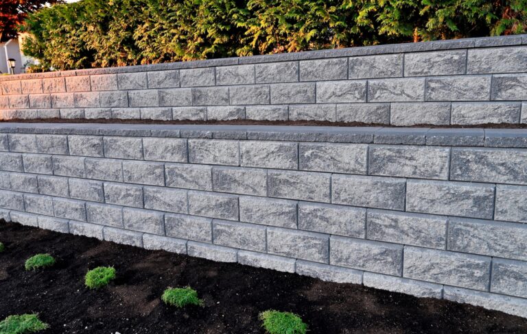 retaining wall closeup gray concrete blocks 2 tier wall existing garden landscape